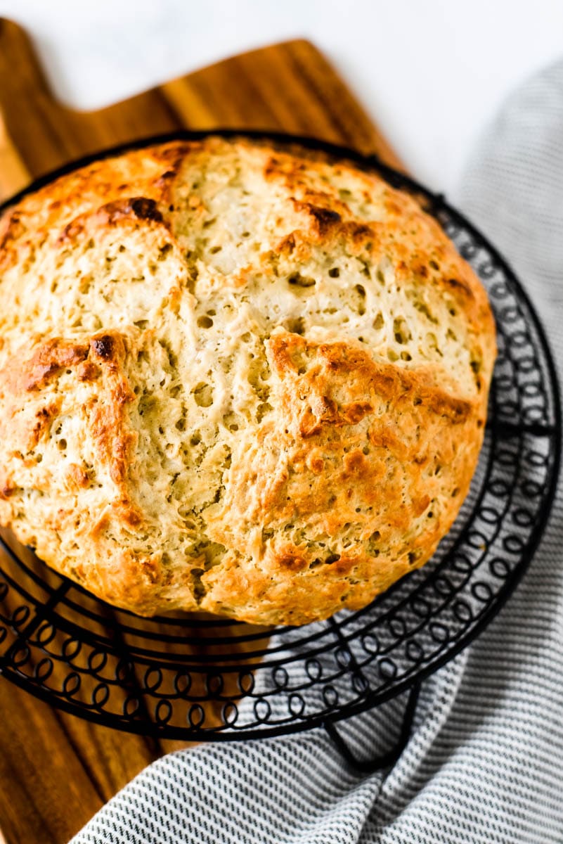 sourdough irish soda bread loaf on wooden cutting board