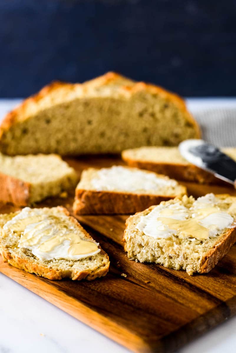 slices of sourdough irish soda bread smeared with butter and drizzled with honey