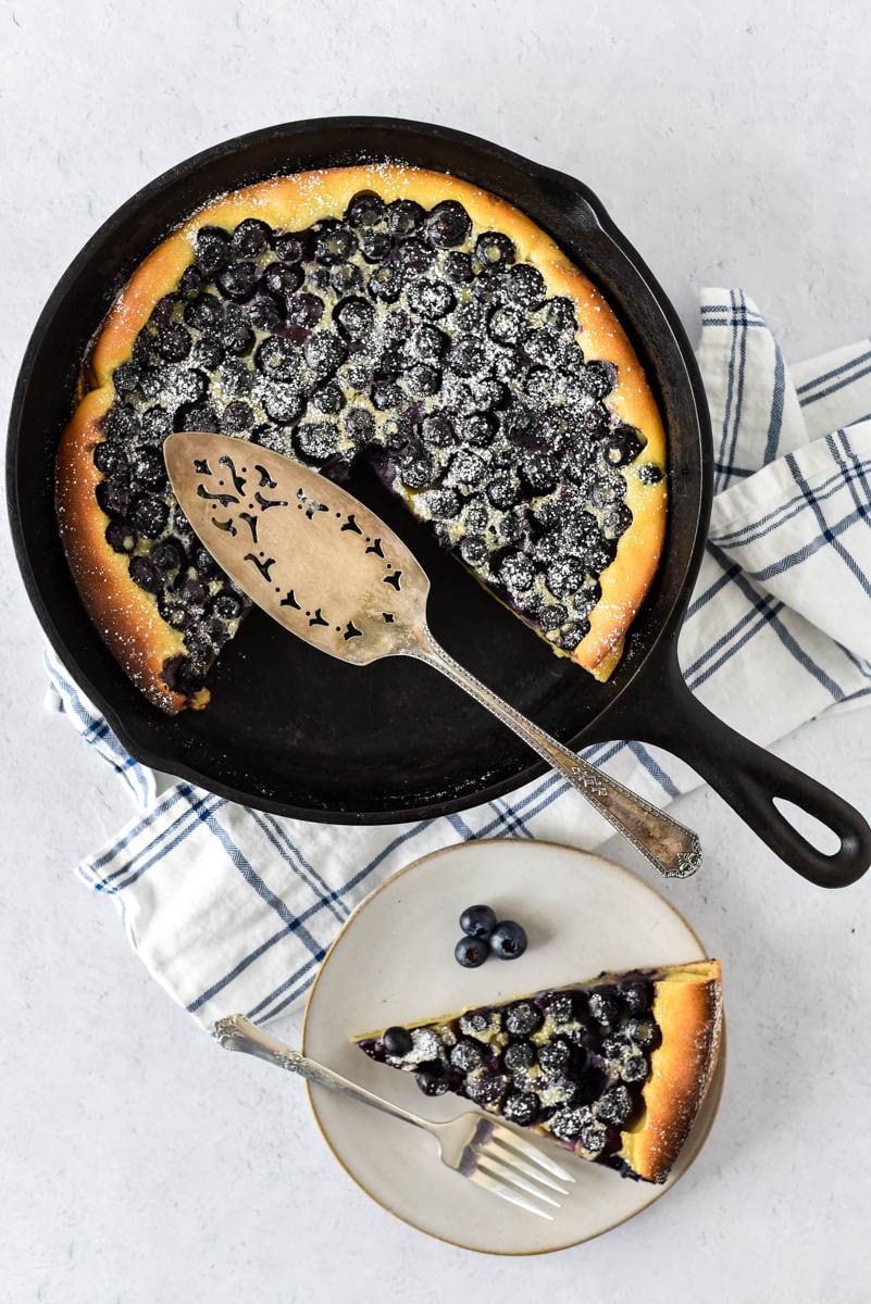 cast iron skillet with clafoutis and blueberries 