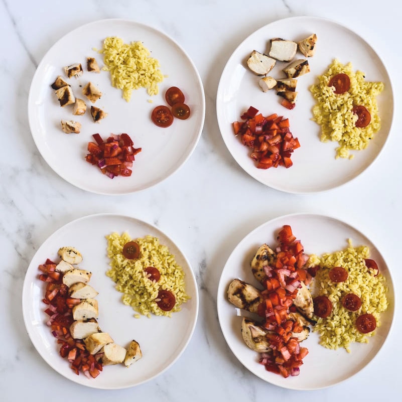 four plates showing chicken with strawberry salsa plated for different aged kids