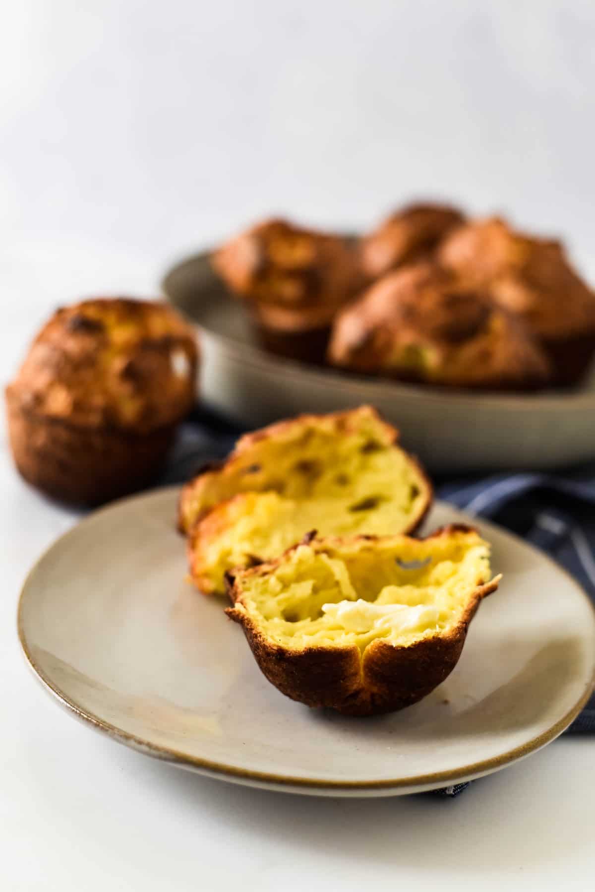 split open popover on plate with more behind