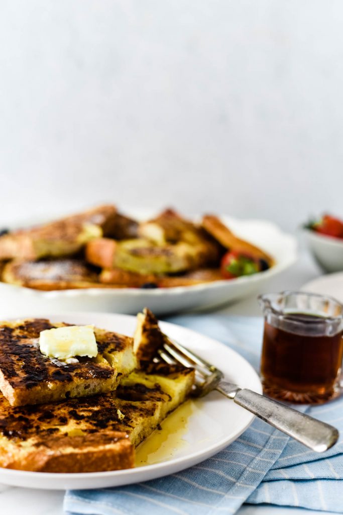 french toast on plate with syrup and fork