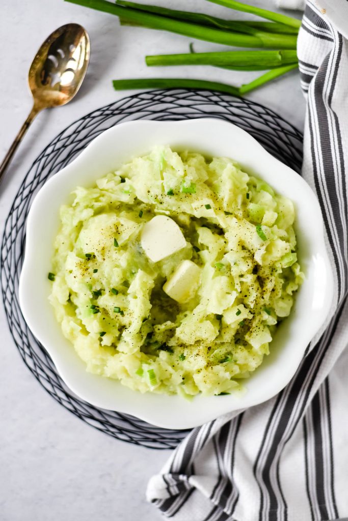 colcannon potatoes in white bowl with serving spoon