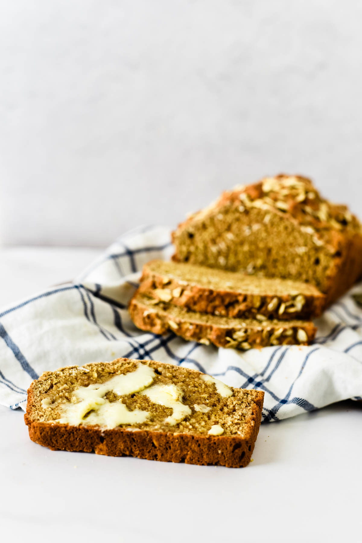 freshly baked wheaten bread with slices and butter