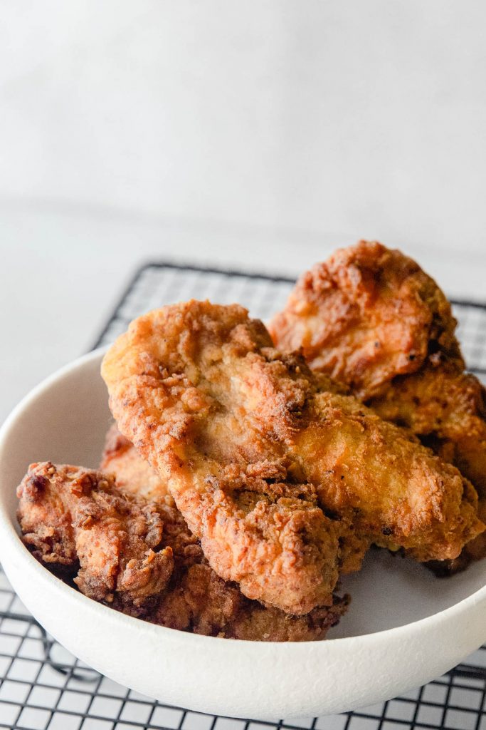 fried chicken in bowl on wire rack