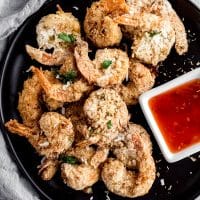 black platter with coconut shrimp and dipping sauce