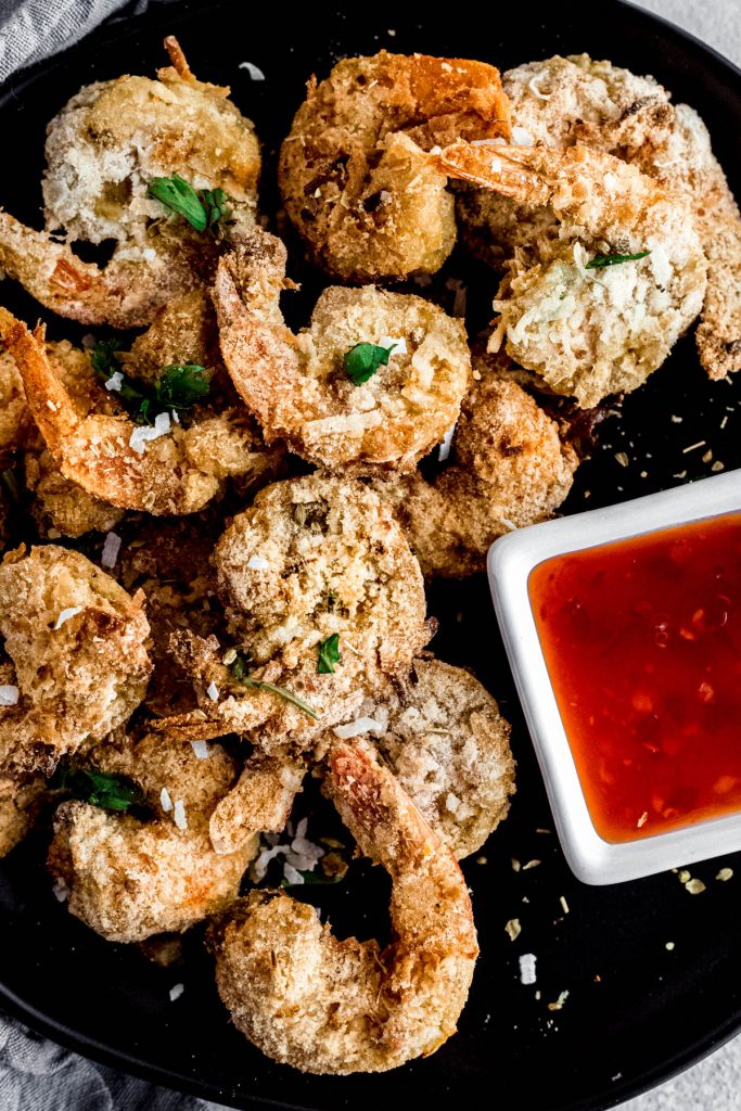 close up image of air fryer shrimp with dipping sauce