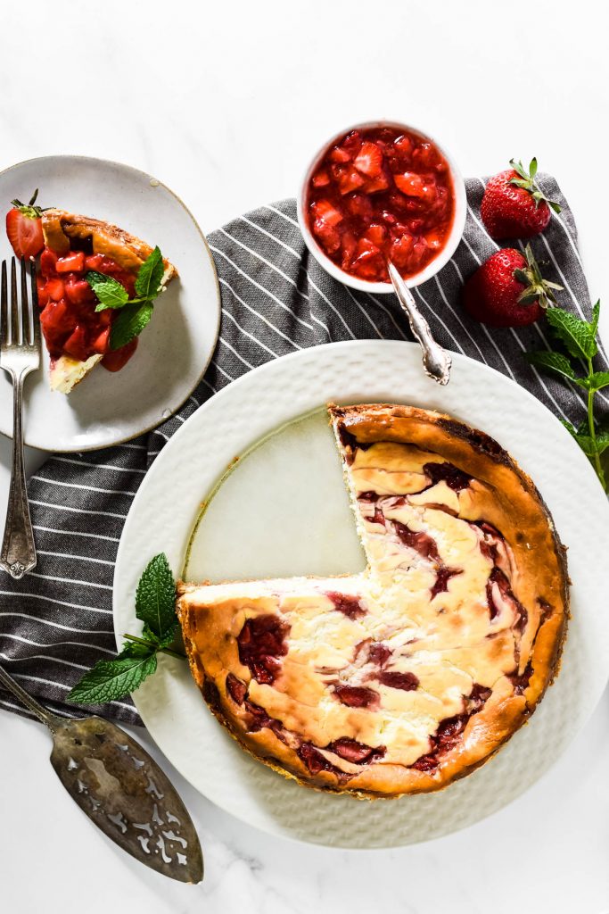 overhead image of cheesecake with strawberry topping in bowl
