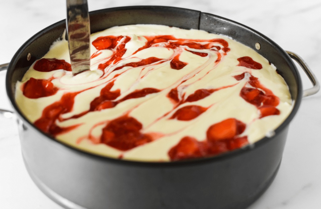using knife to create swirls in cheesecake