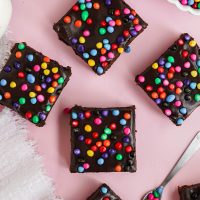 brownies with candy sprinkles on pink board