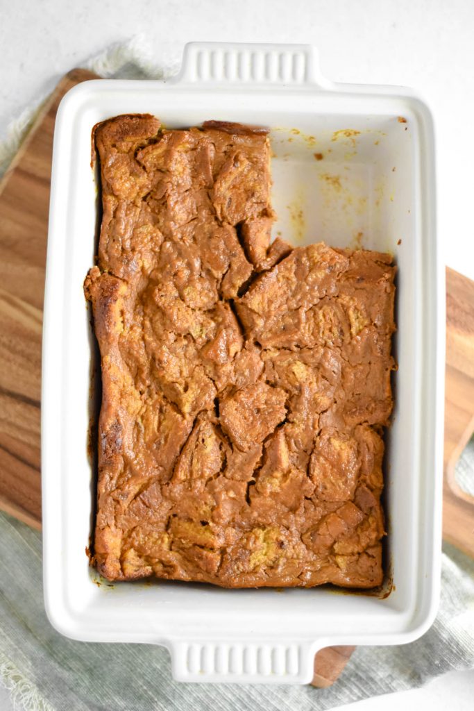 baking pan with bread pudding and piece missing
