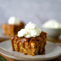 bread pudding slice with whipped cream on plate