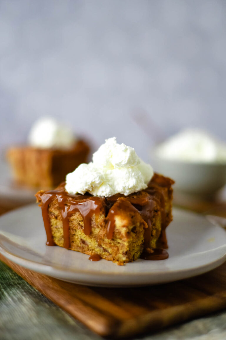 bread pudding slice with whipped cream on plate