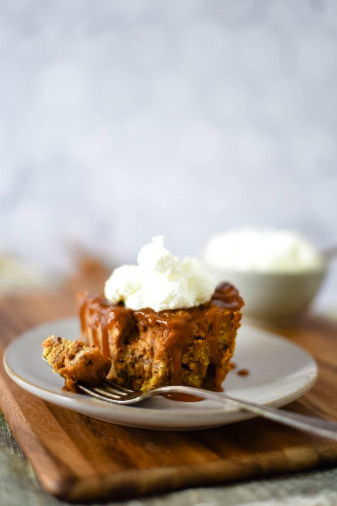 slice of cinnamon bread pudding with bite on fork 