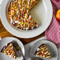 apple cake on platter with two plates