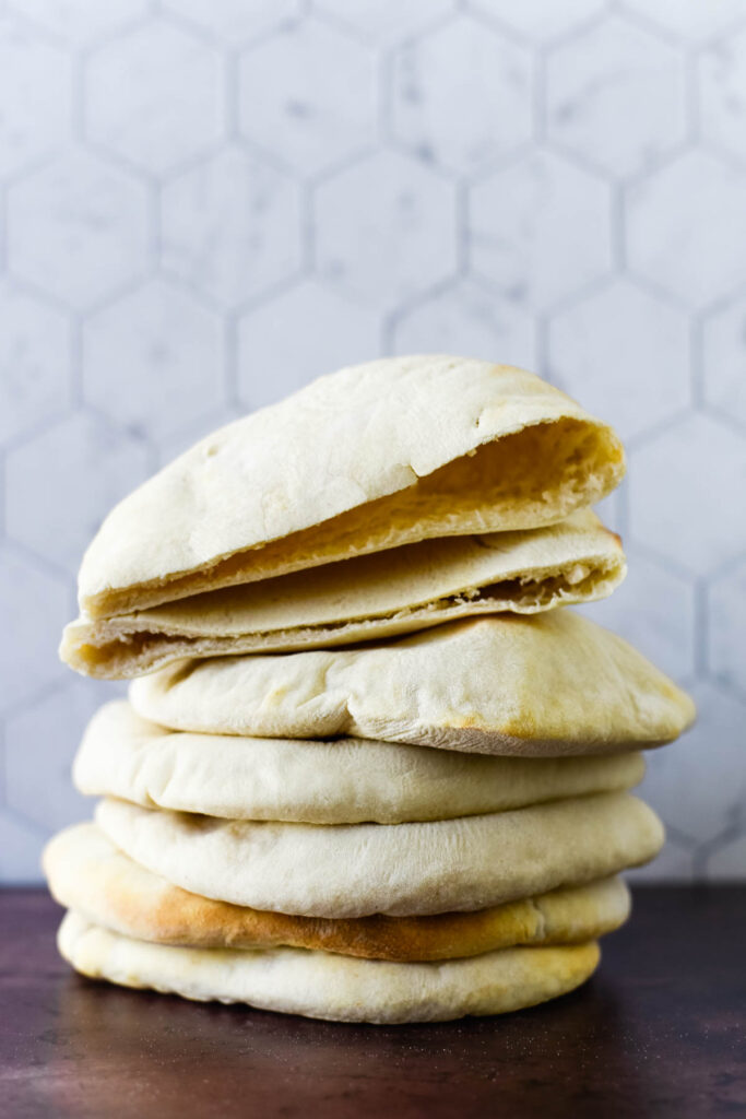 stack of sourdough pita with top one cut open