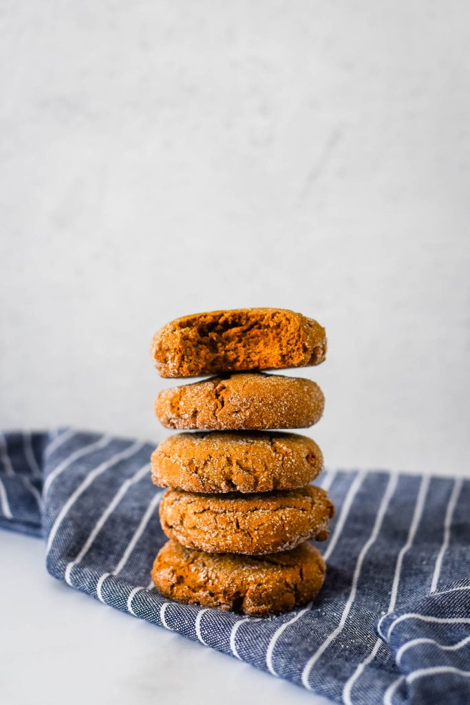stack of molasses sourdough discard cookies with bite taken from top cookie 