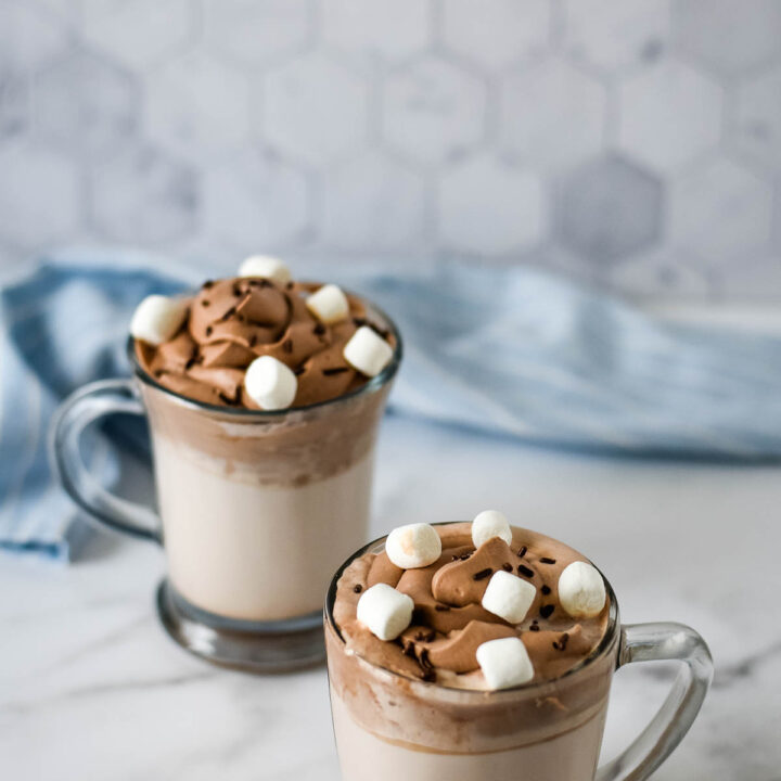 two mugs of whipped hot chocolate with marshmallows