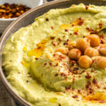 closeup of hummus topped with chickpeas and paprika