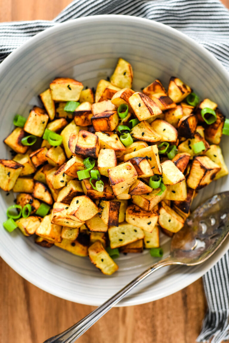 diced roasted japanese sweet potatoes in bowl with serving spoon