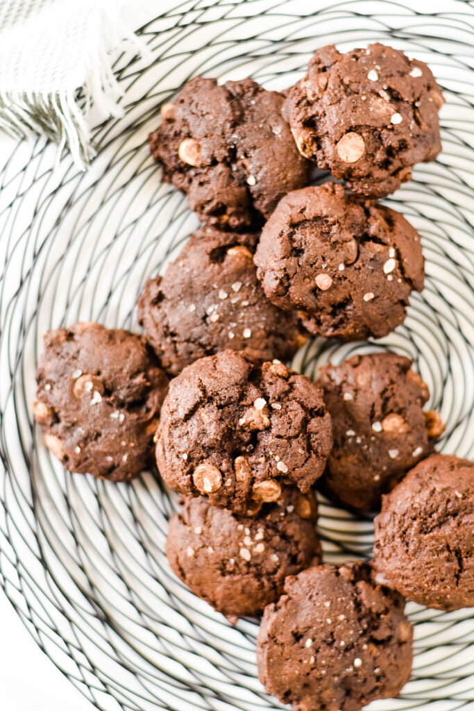 chocolate rye sourdough cookies piled on wire cooling rack