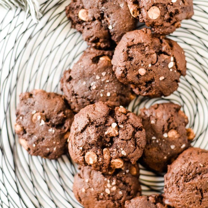 chocolate rye sourdough cookies piled on wire cooling rack
