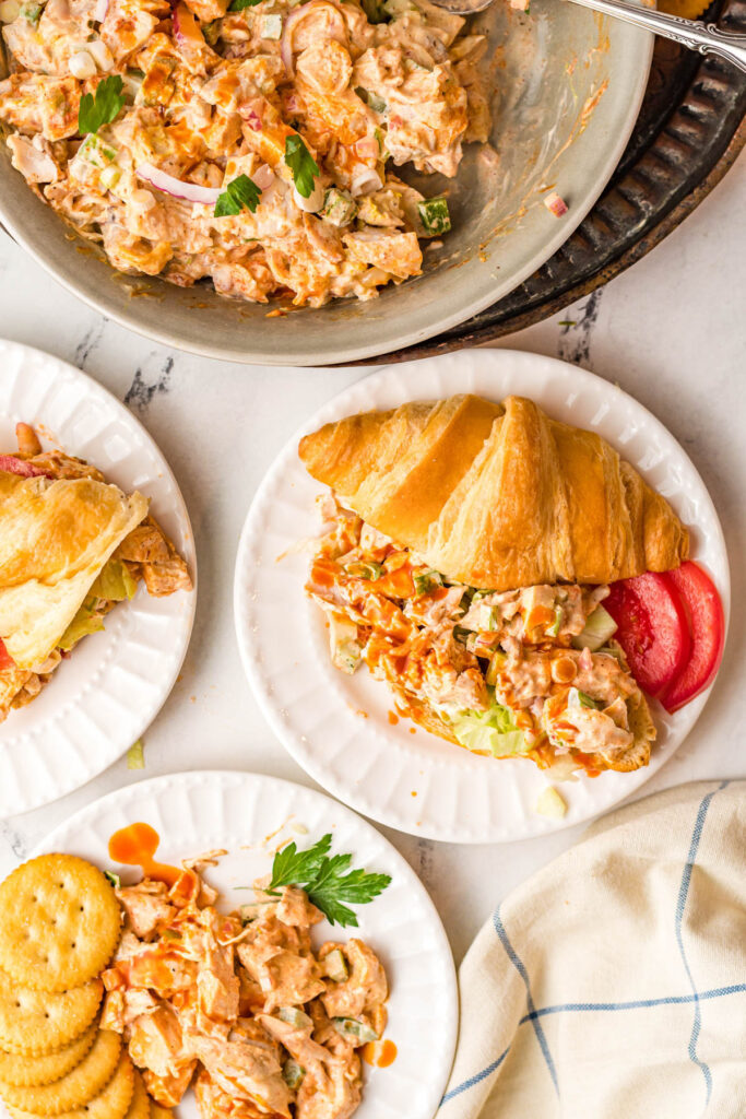 plates with servings of cajun chicken salad with croissants