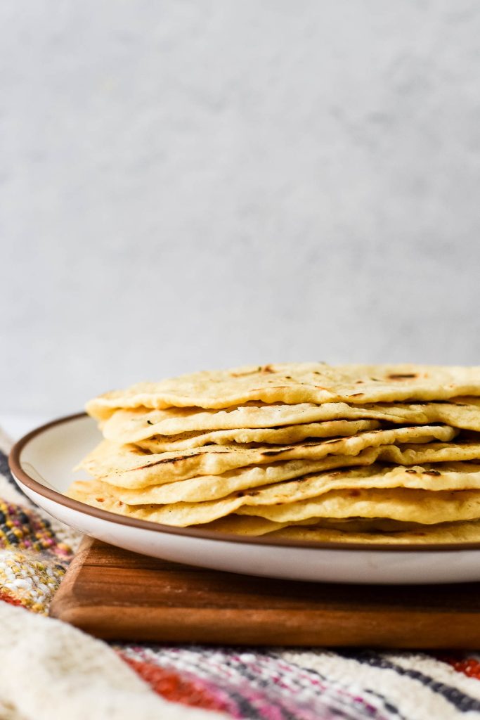 stacked tortillas on white plate