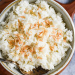 closeup of coconut rice in bowl with spoon