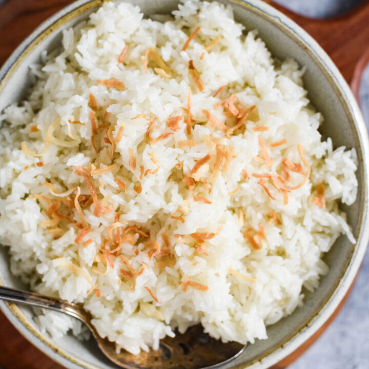 closeup of coconut rice in bowl with spoon