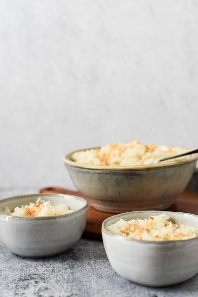 image of three bowls with rice and spoons