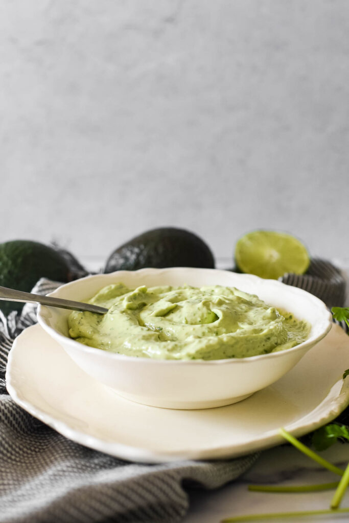 avocado sauce in white serving bowl with spoon