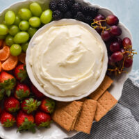 marshmallow fruit dip in bowl surrounded by fruit