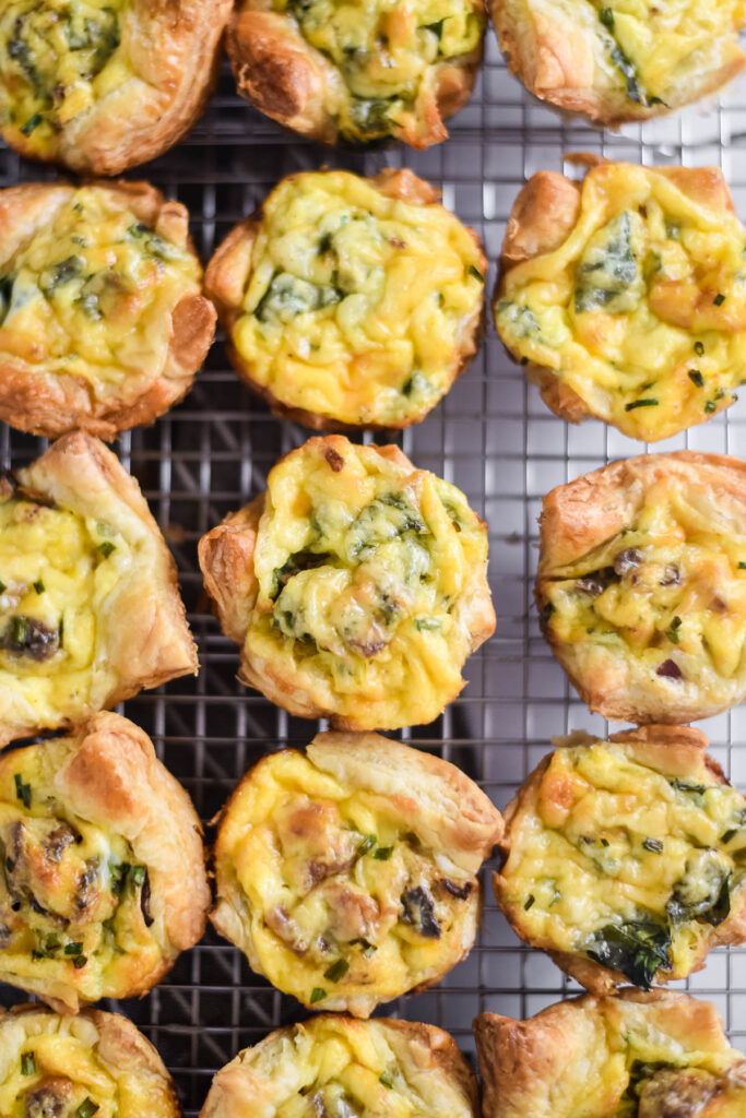 puff pastry quiches lined up on cooling rack