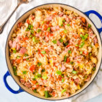 blue pan filled with ham and pineapple fried rice