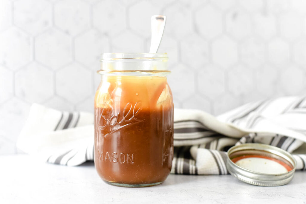 salted caramel sauce in mason jar with spoon