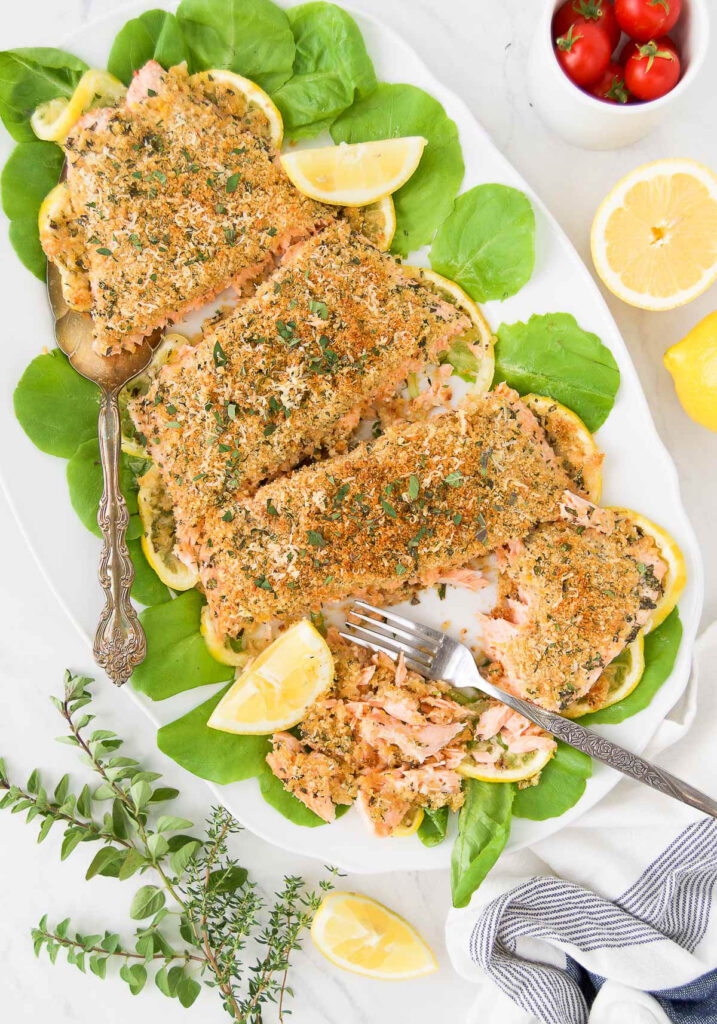 salmon filet with herbs and breadcrumbs with fork showing tender flakey texture