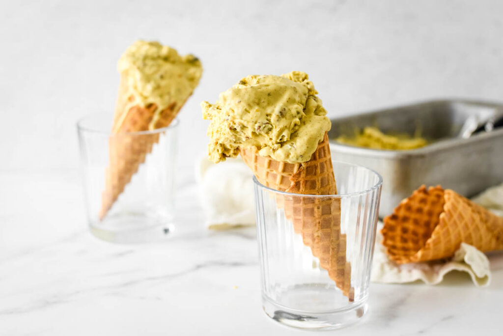 ice cream cones with pistachio ice cream standing in glasses 