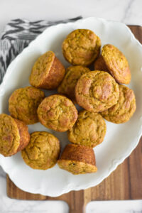 pumplin banana muffins piled on white platter