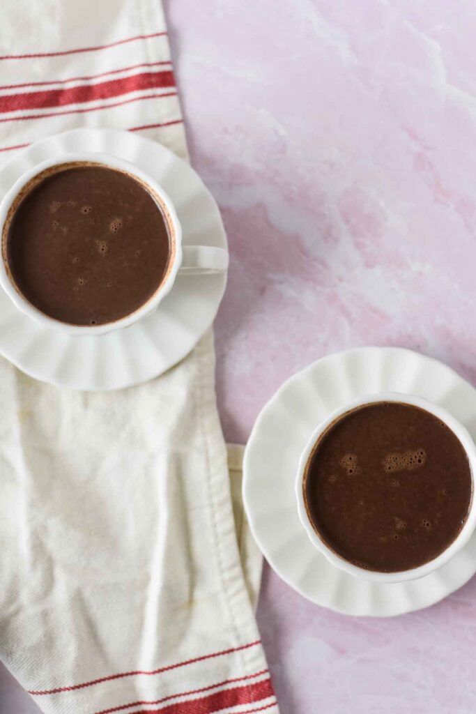 two white mugs with Spanish hot chocolate