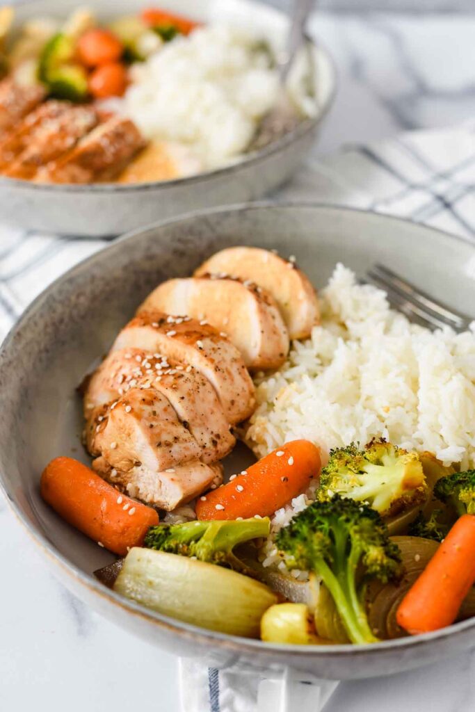 two bowls with teriyaki chicken rice and vegetables