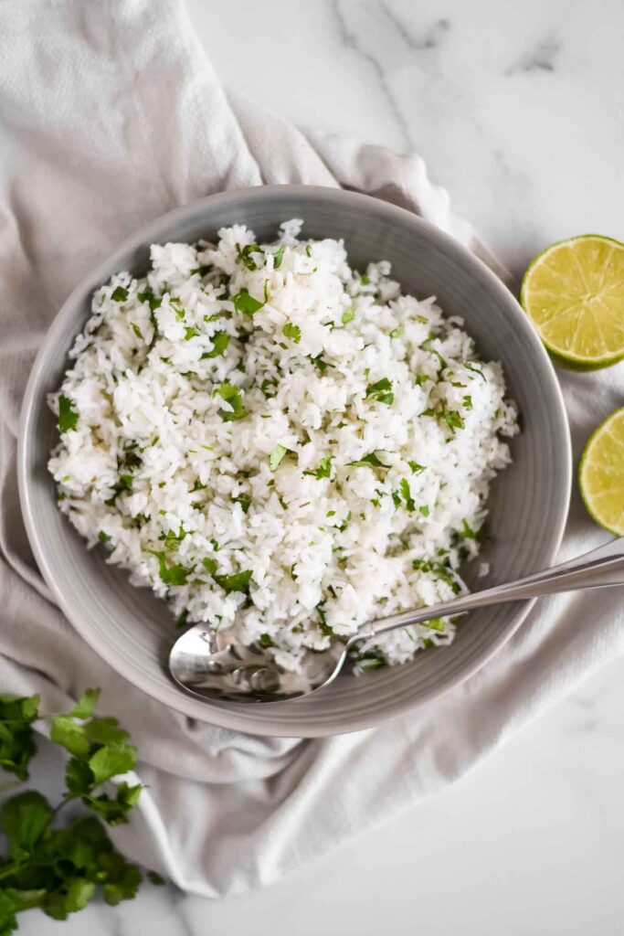 rice with cilantro and lime in serving bowl with spoon
