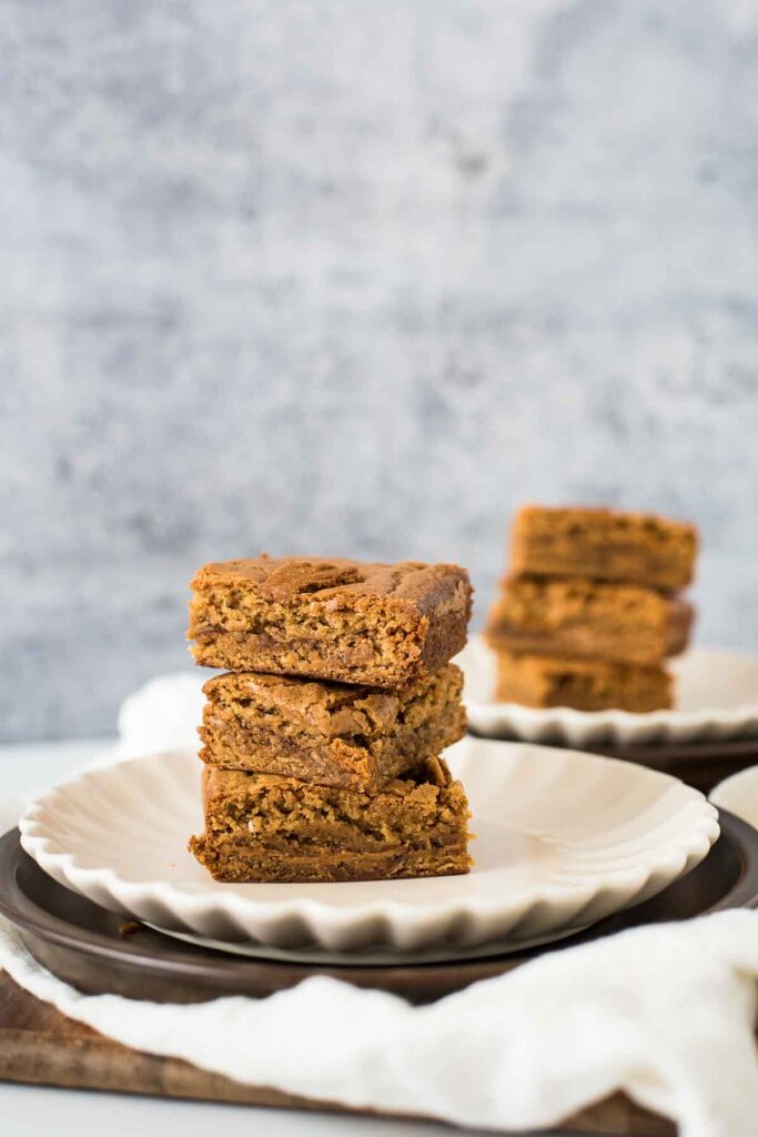 biscoff blondie bars stacked three high on two plates