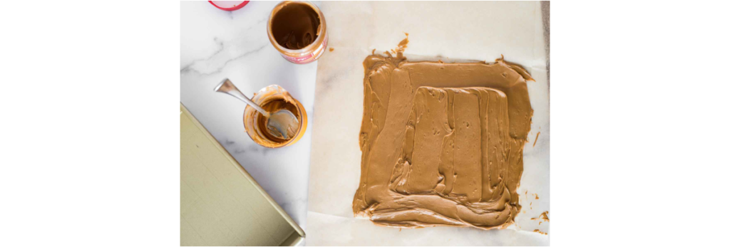 spreading biscoff on parchment paper square