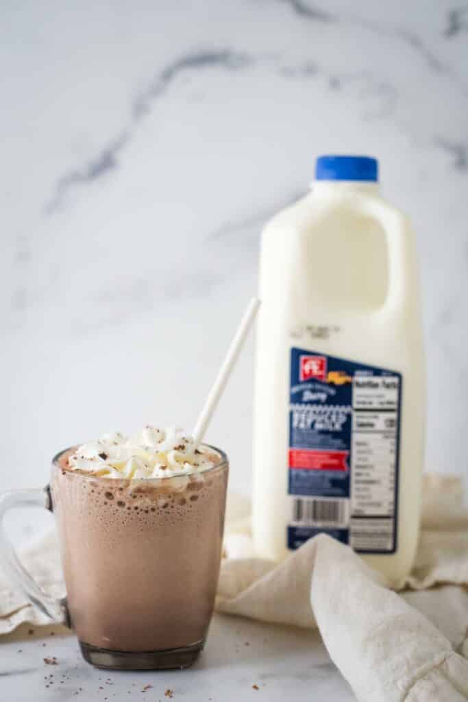 glass mug with frozen hot chocolate next to bottle of AE Dairy 2% milk
