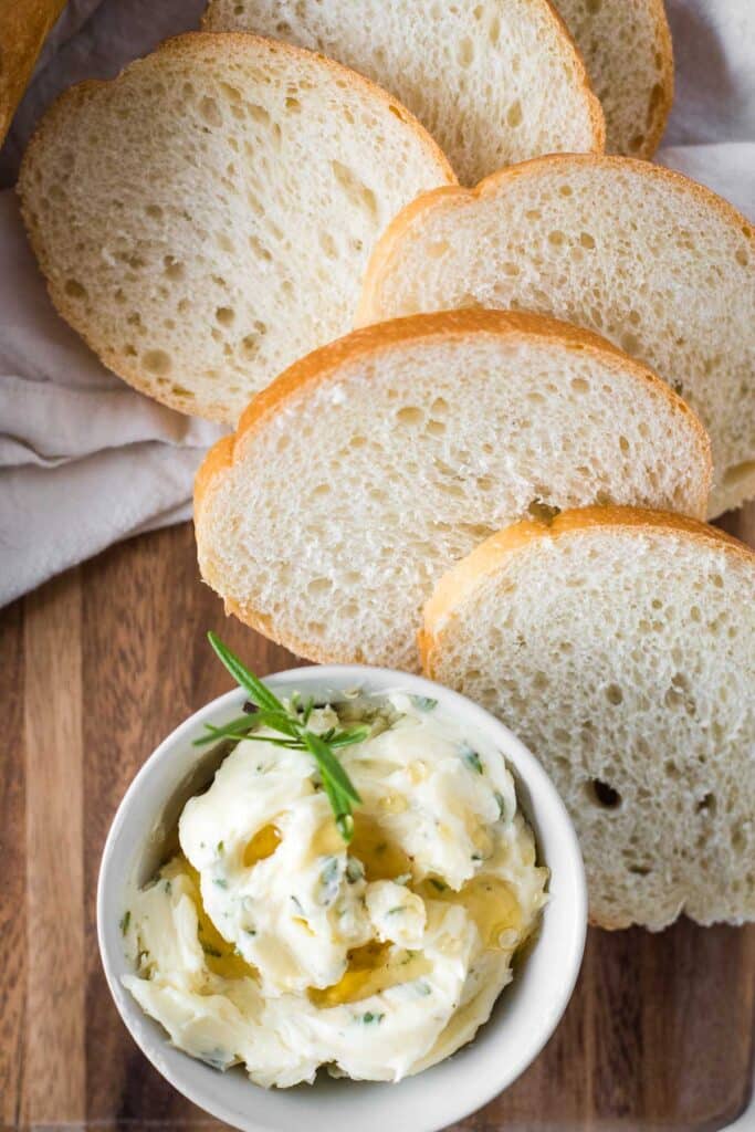 bowl of honey butter surrounded by bread slices