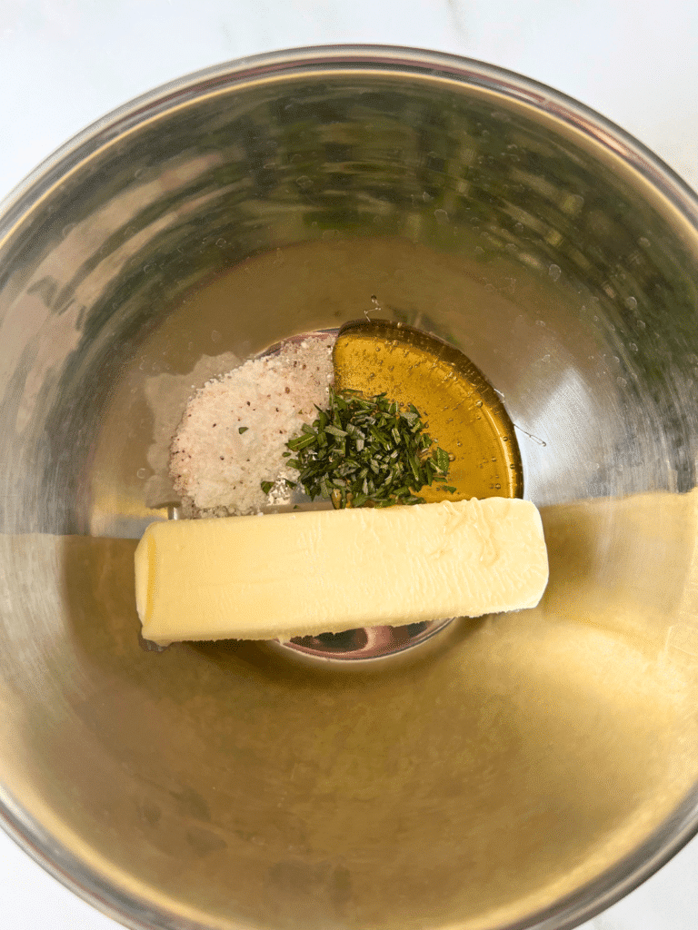 mixing honey butter ingredients in metal mixing bowl