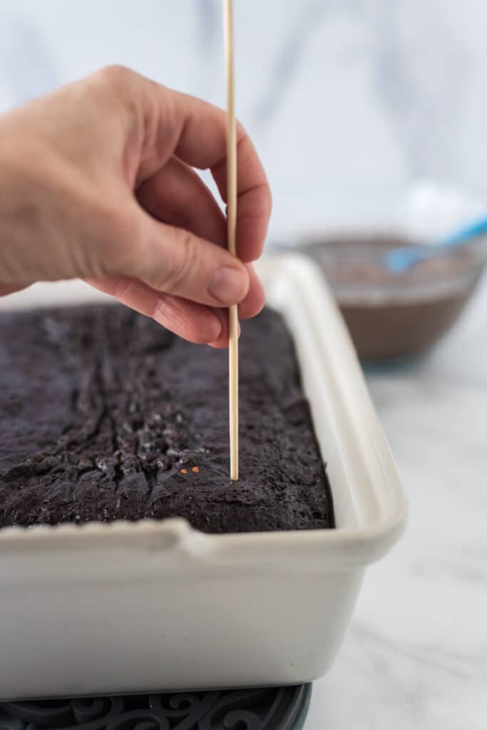 poking baked cake with skewer