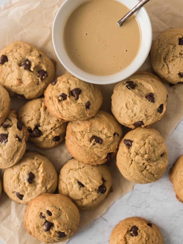 chocolate chip cookies on baking paper next to bowl of tahini