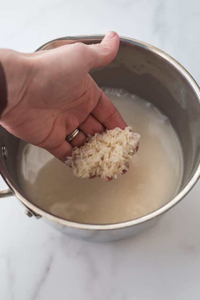 washing rice in saucepan